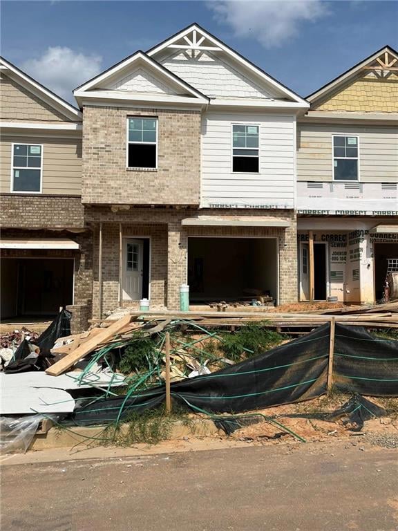 Townhome / multi-family property with brick siding