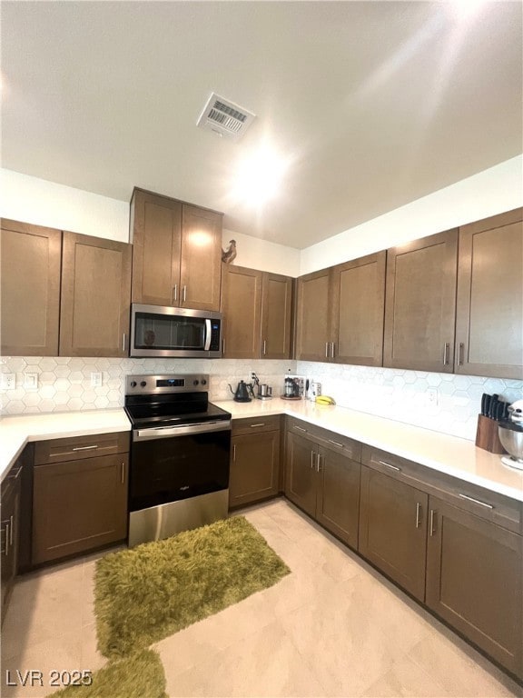 Kitchen with appliances with stainless steel finis