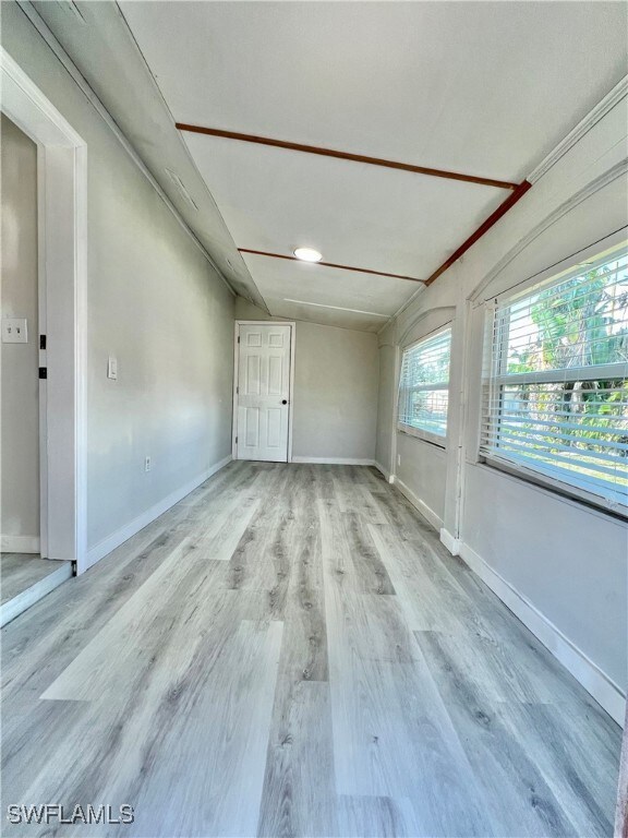 Unfurnished room featuring baseboards and light wood finished floors