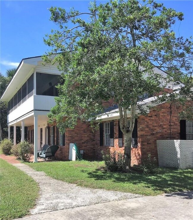 Side view of Side A from the drive and walk way.  Owner plans to replace upper roof in the next year.