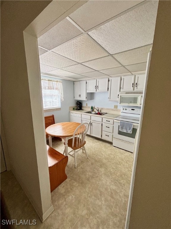 Kitchen with white appliances, light countertops,