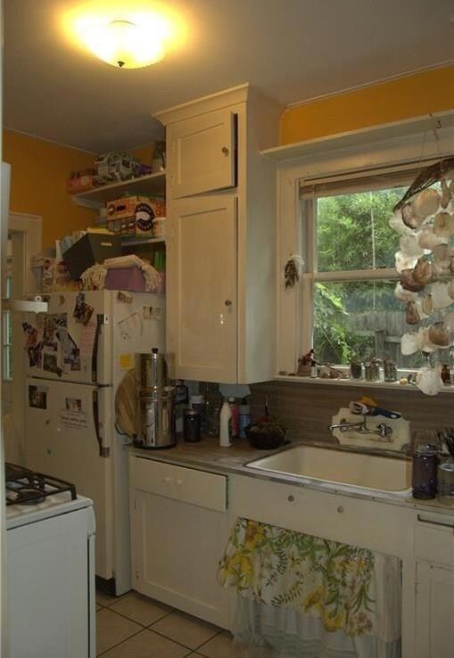 Kitchen with white gas range, light tile patterne