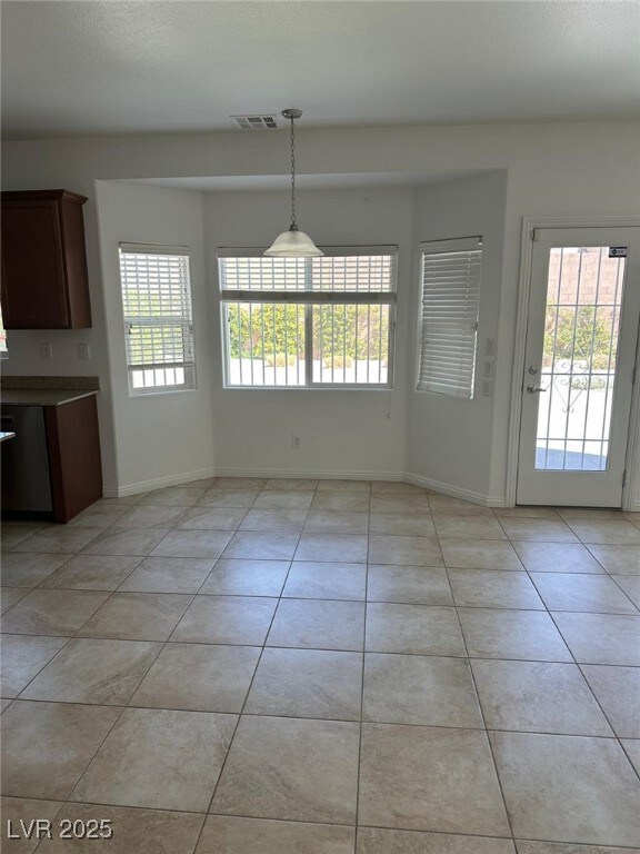 Unfurnished dining area with visible vents, light