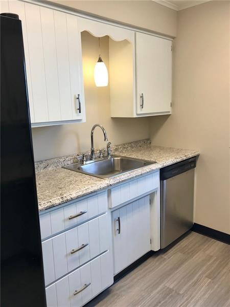 Kitchen has new floors, dishwasher and refrigerato