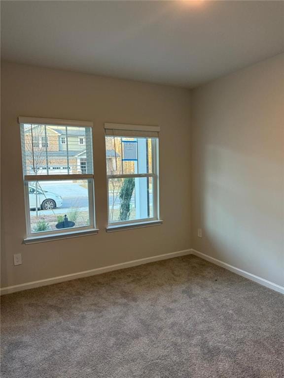 Unfurnished room with carpet floors and baseboards