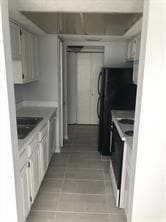 Kitchen featuring a sink, light tile patterned flo