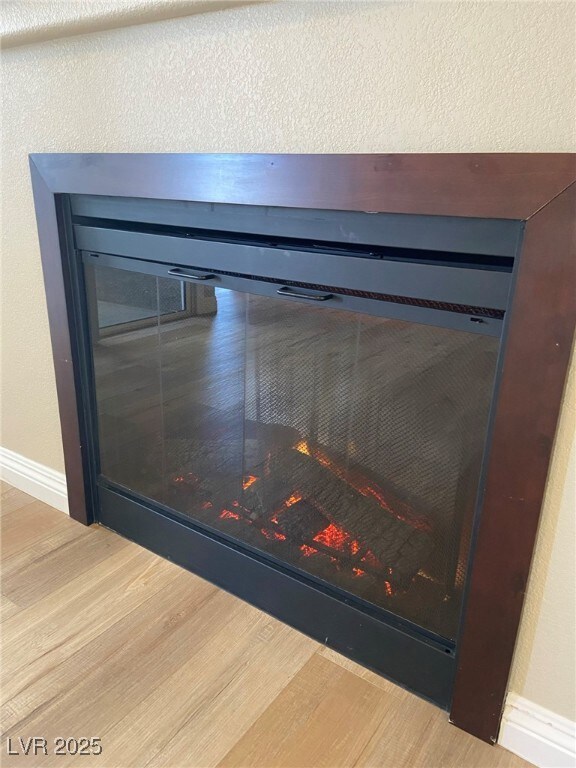 Detailed view of wood finished floors and baseboar