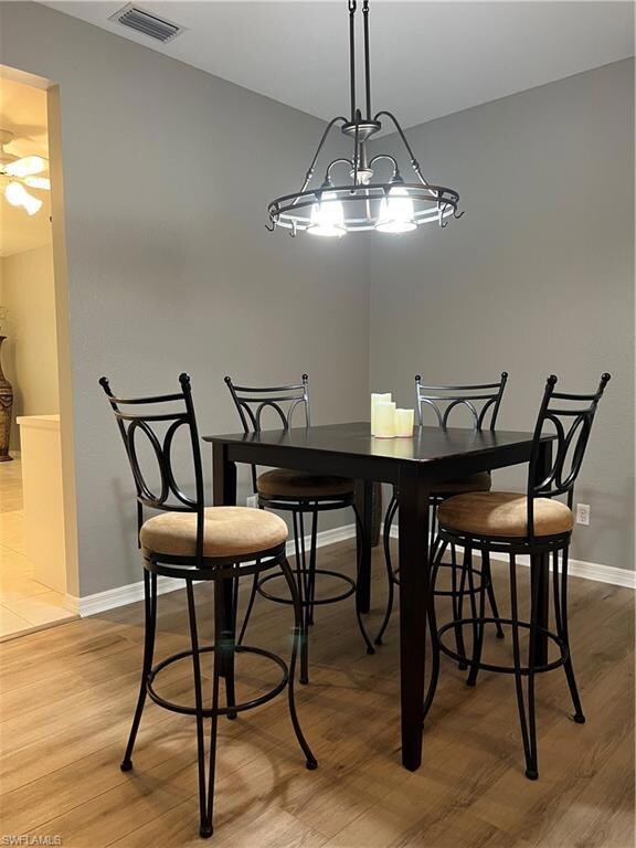 Living room with ceiling fan with notable chandeli