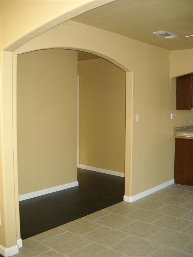 Hallway features wood laminate flooring and two to