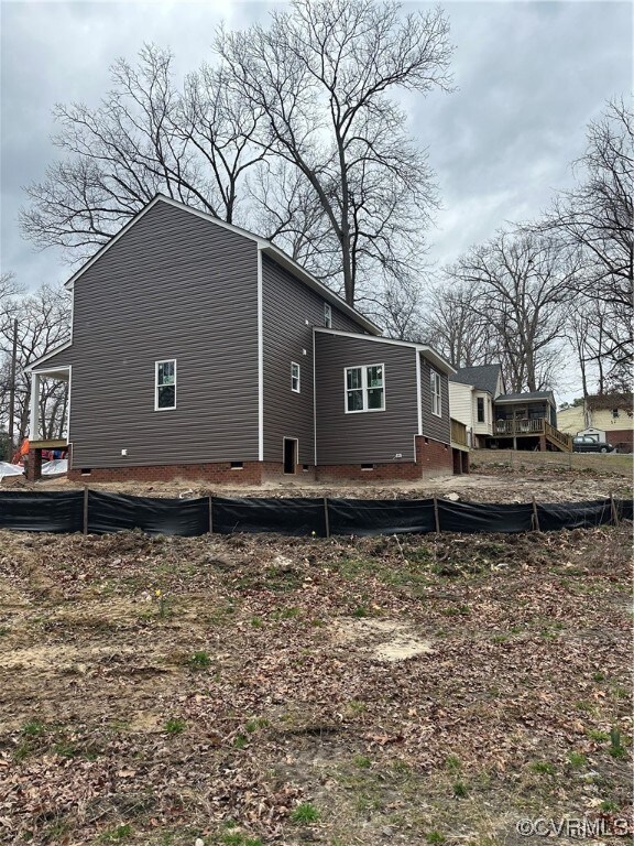 View of side of property with a wooden deck