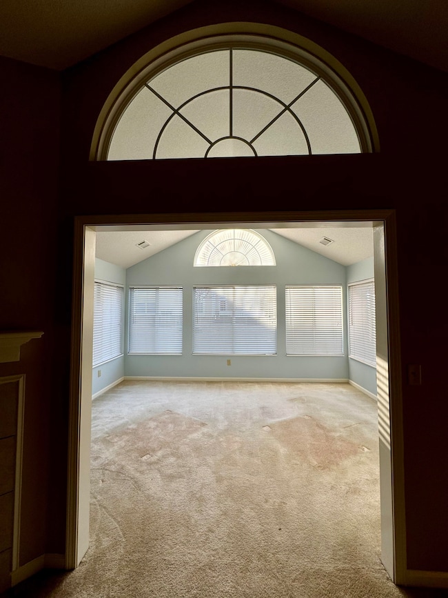 Spare room featuring a wealth of natural light, lo