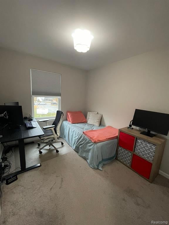 Bedroom featuring a desk and light colored carpet