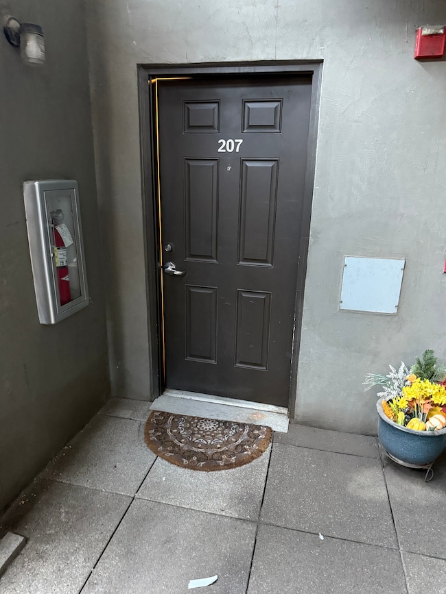 Entrance to property featuring stucco siding