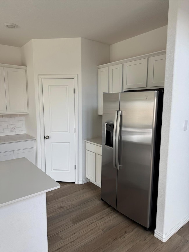 Kitchen with dark wood-style floors, light counter