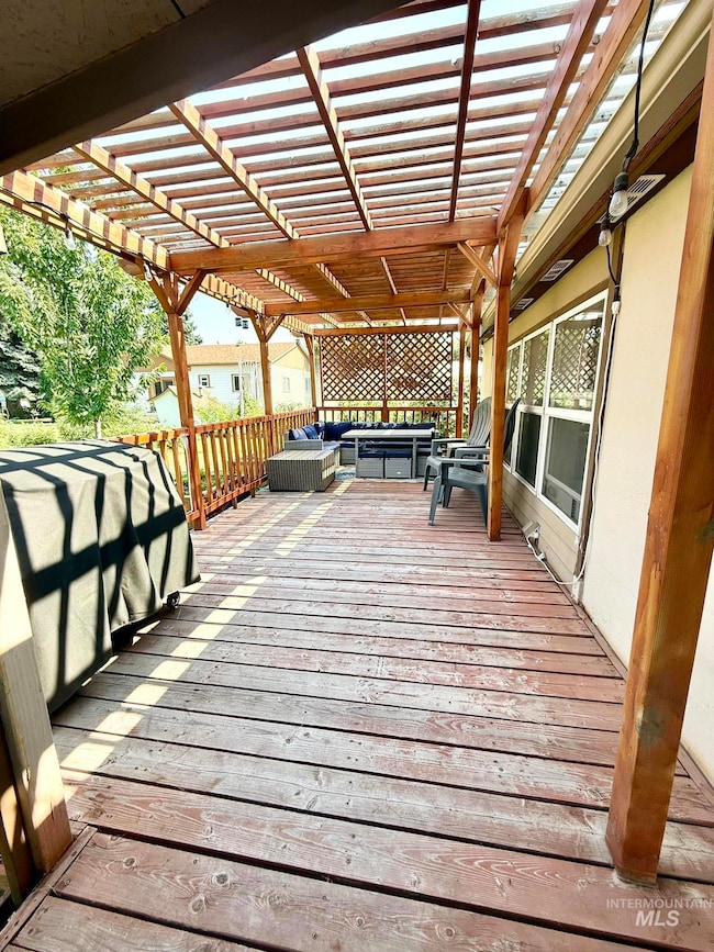 Deck with an outdoor hangout area and a pergola