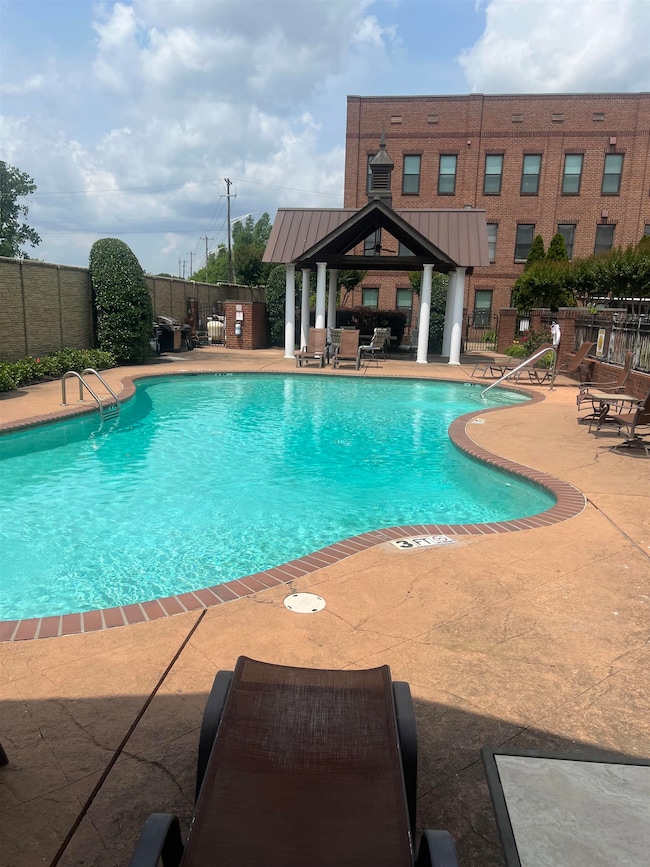 Community pool featuring a gazebo and a patio area