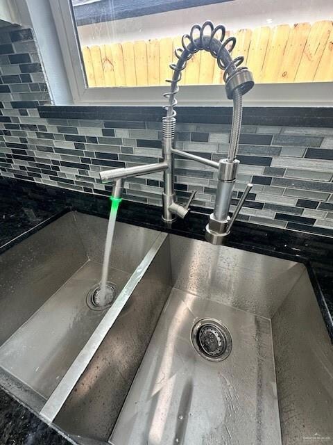 Kitchen view of decorative backsplash and a sink