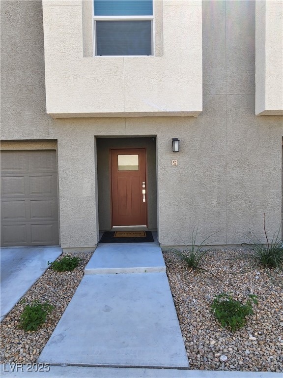 Property entrance featuring stucco siding