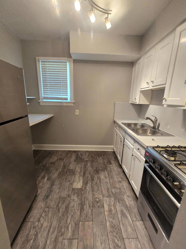 Kitchen featuring white cabinets, stainless steel 