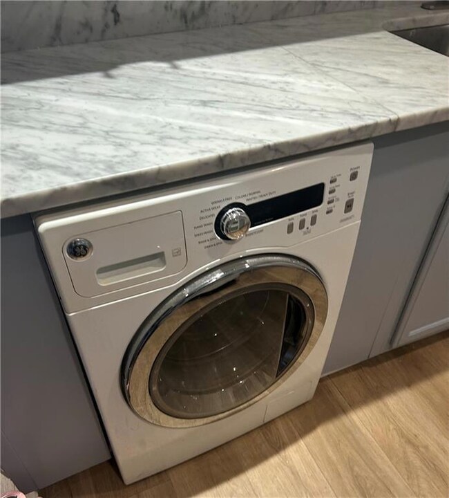 Clothes washing area featuring washer / clothes dr