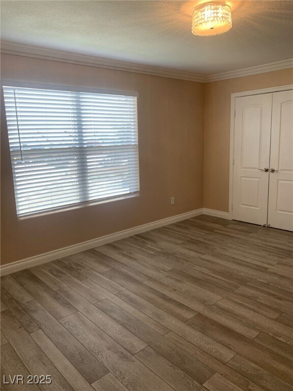 Empty room with baseboards, a textured ceiling, wo