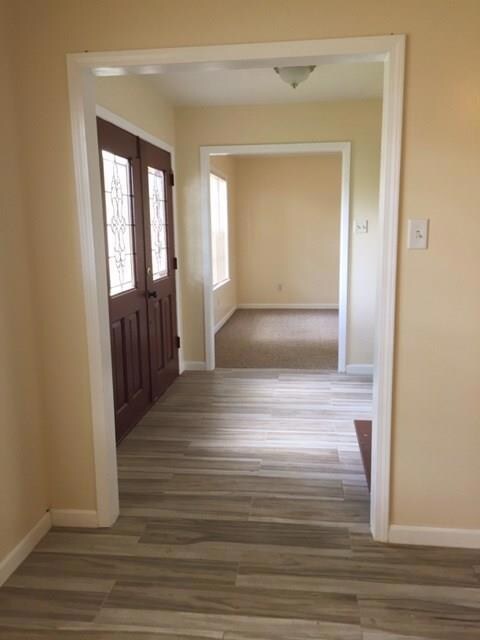 Foyer as you walk in the formal living room and dining on left den on right