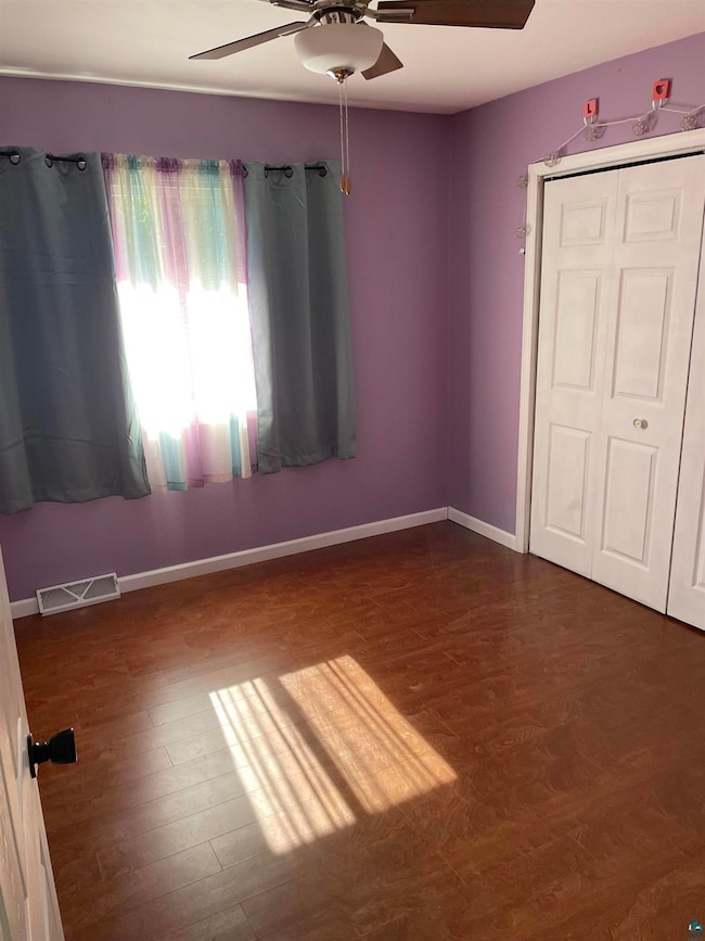 Unfurnished bedroom featuring dark wood-type floor
