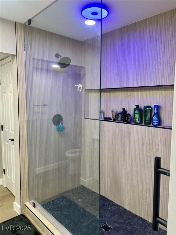 Full bath featuring wood finished floors and walk