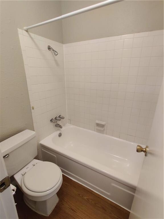 Full bath featuring wood finished floors,  shower