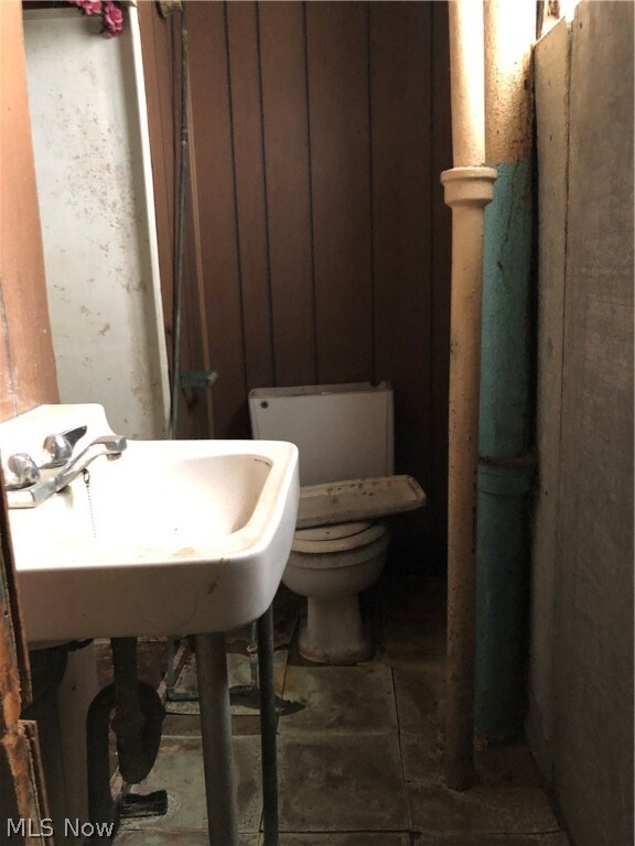 Bathroom featuring tile floors and toilet