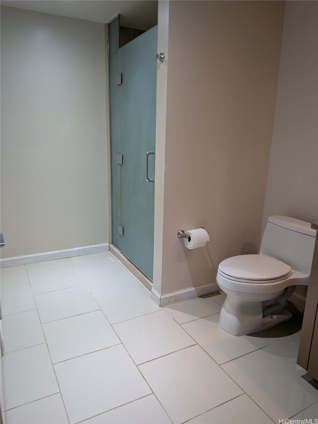 The shower is roomy and features a glass door