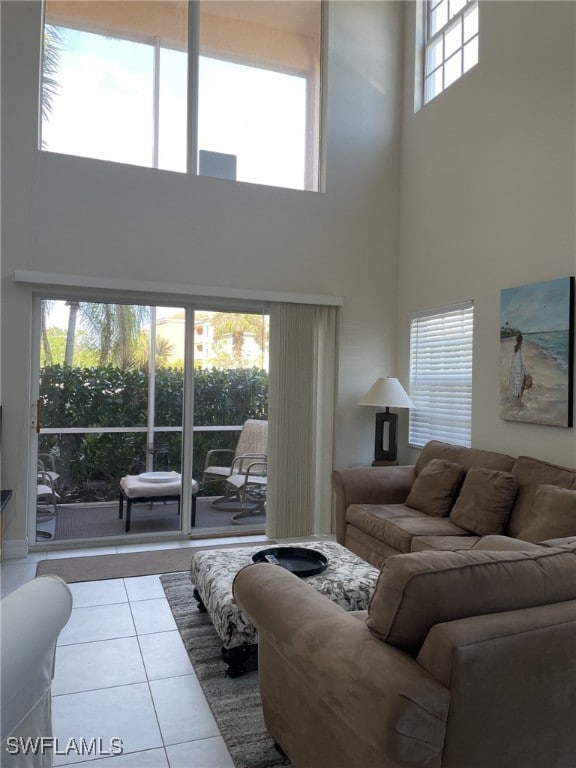 Tiled living area featuring a high ceiling