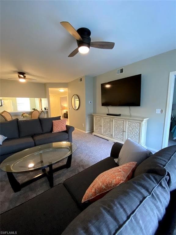 Carpeted living room with ceiling fan