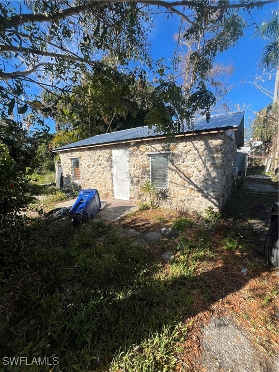 View of property exterior featuring stone siding