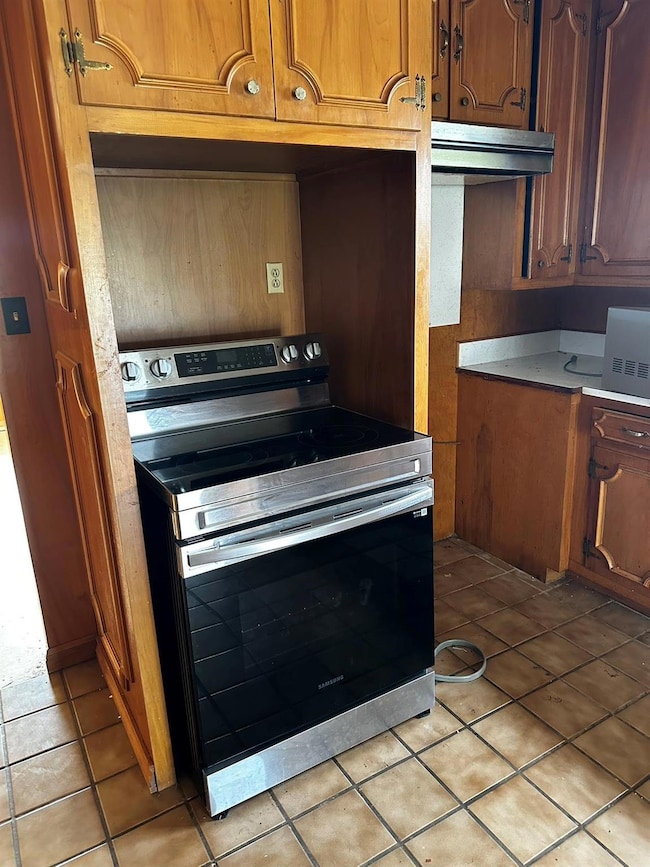 Kitchen featuring light tile patterned floors and 
