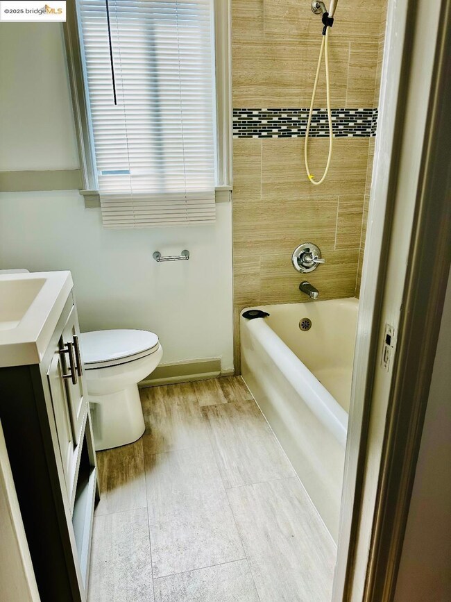 Full bath featuring vanity and shower / tub combination