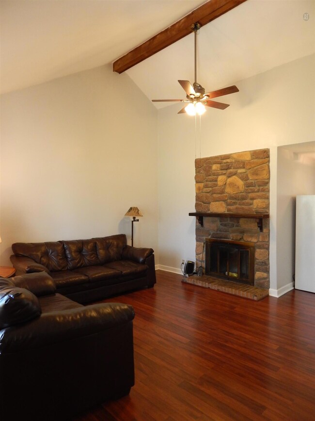 Living area has vaulted, beamed ceiling and stone, wood burning fireplace.  Home freshly painted throughout.