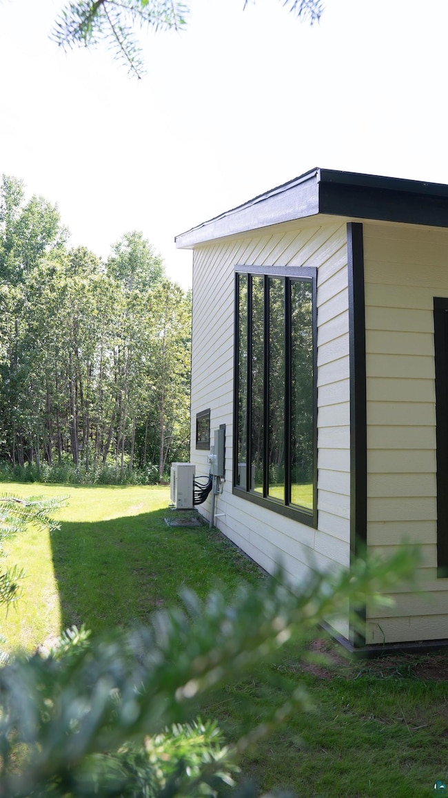 View of side of property featuring a lawn