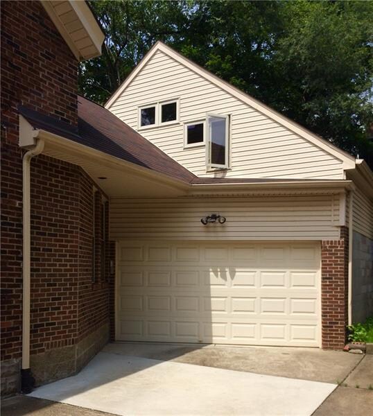 View shows added wing and attached garage.