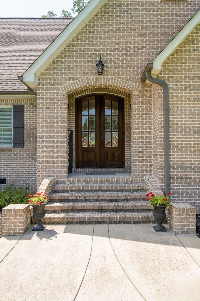 As you approach the home, the first thing that catches your eye is the wide sidewalk that leads up to the brick steps.  This grand entrance creates a welcoming and elegant feel right from the start.