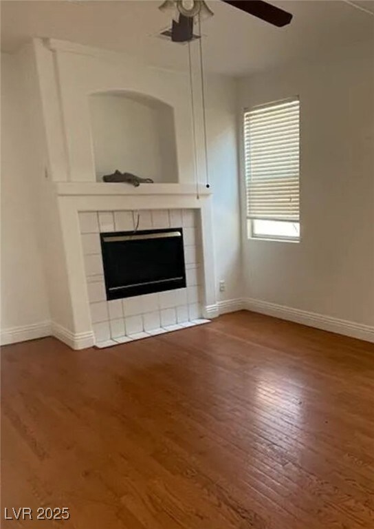 Unfurnished living room with a tiled fireplace, ce