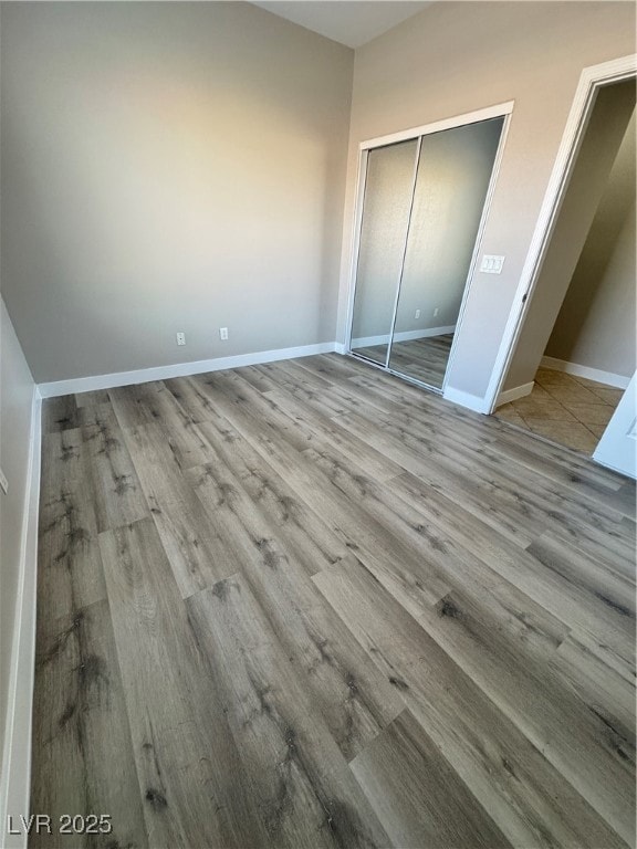 Downstairs bedroom featuring a closet, baseboards,