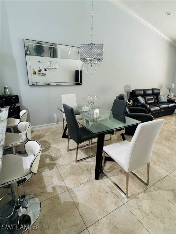 Dining room featuring ornamental molding and a cha
