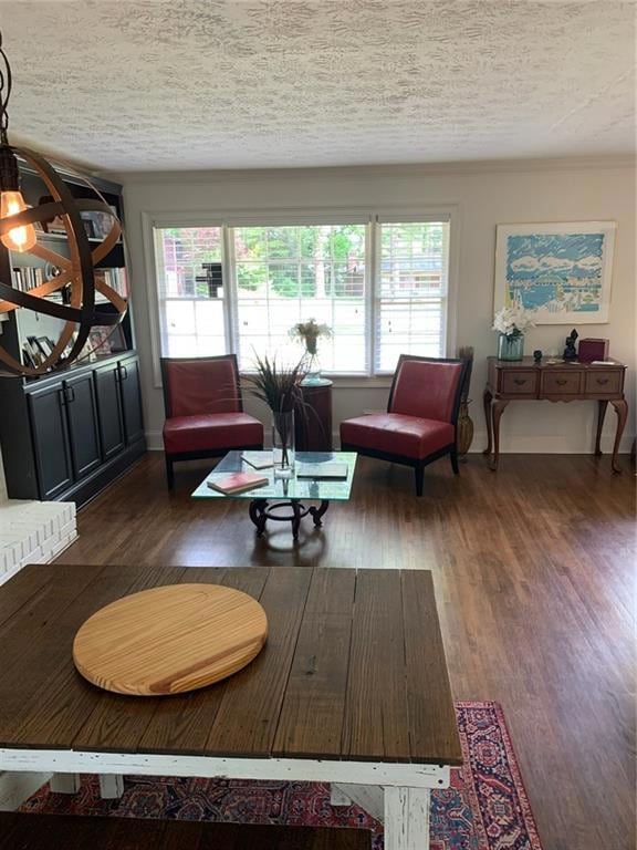 Living area featuring wood finished floors and a textured ceiling