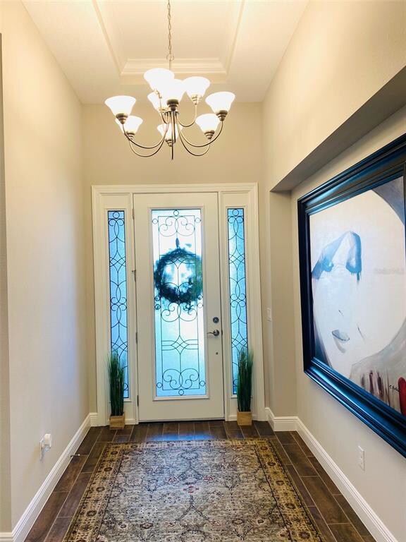 Foyer entry features tall ceilings with tray ceili