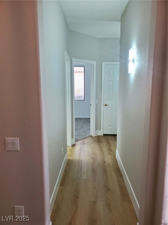 Hall featuring hardwood / wood-style floors and ba