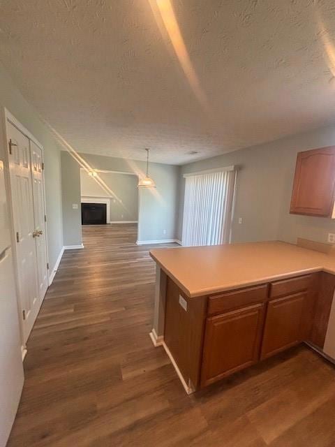 Kitchen with a textured ceiling, dark wood-style f