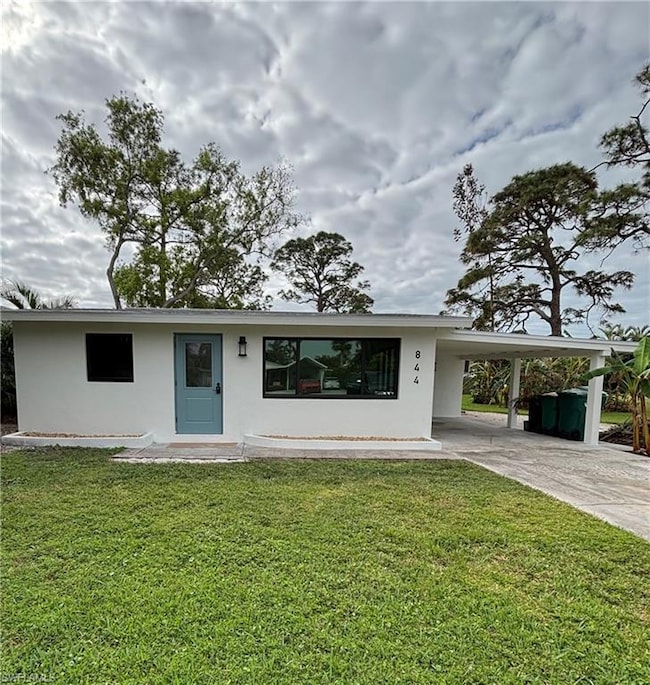 View of front of home with a carport and a front l