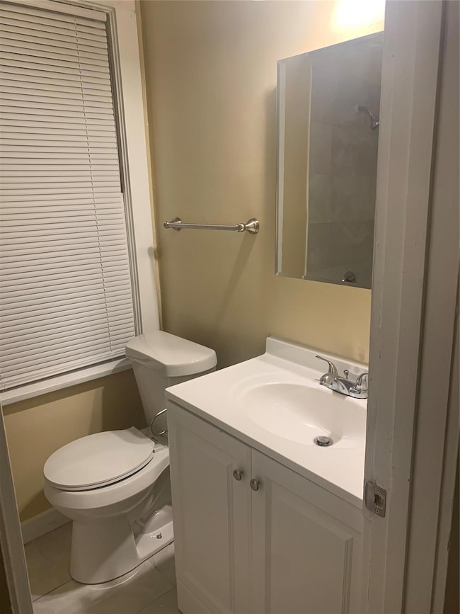 Bathroom featuring tile patterned flooring, toilet