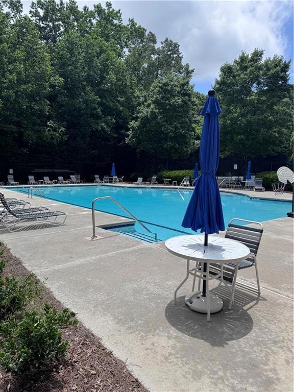 Community pool featuring a patio area